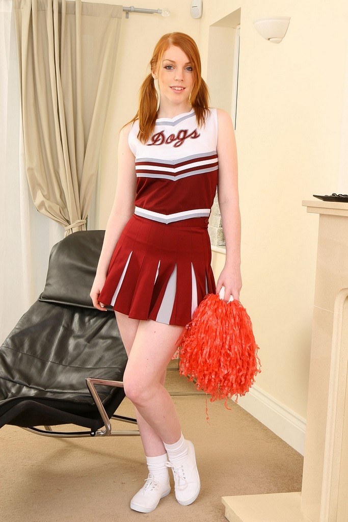 Redhead Cheerleader with Pigtails wearing White Socks, Sneakers and Red Pleated Short Dress